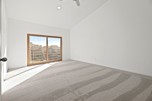 carpeted spare room with lofted ceiling and ceiling fan