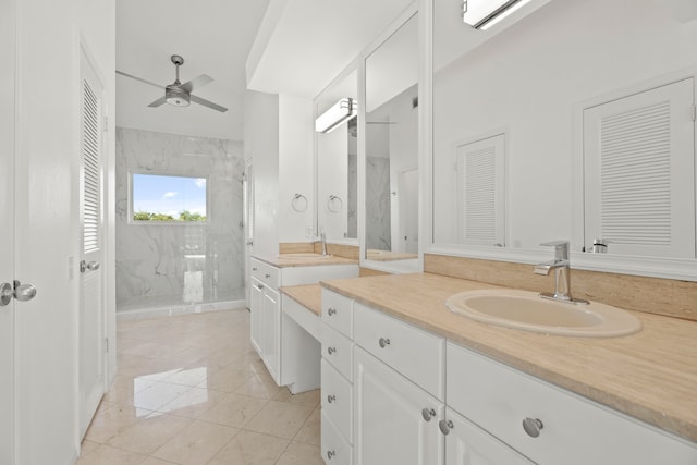 bathroom featuring vanity, ceiling fan, tiled shower, and tile patterned flooring