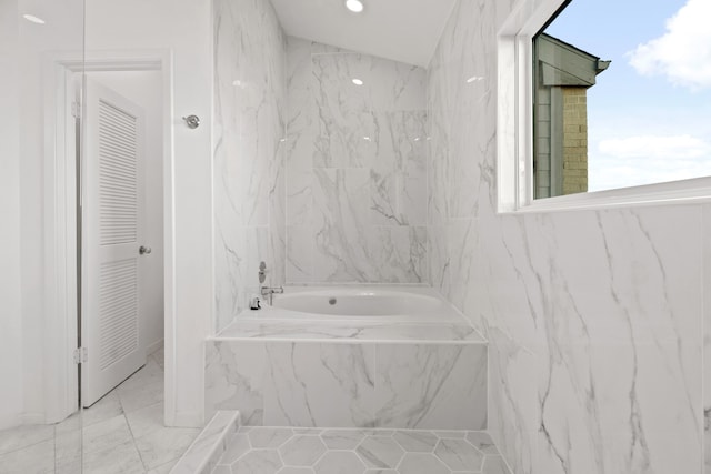 bathroom with tiled tub