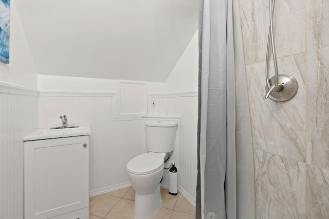 bathroom featuring toilet, sink, tile patterned flooring, and a shower with shower curtain