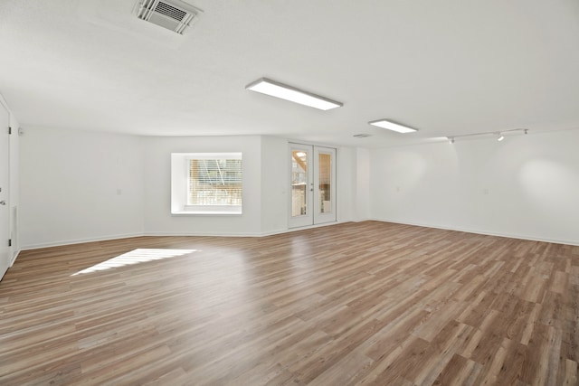 unfurnished room featuring light hardwood / wood-style floors and french doors