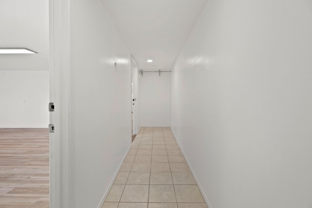 corridor with light hardwood / wood-style flooring