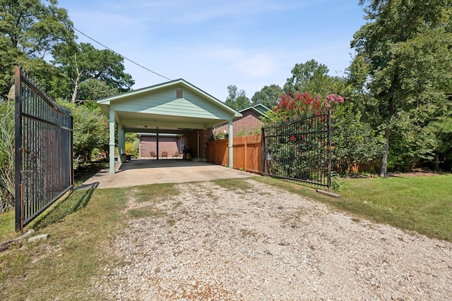 exterior space with a lawn and a carport