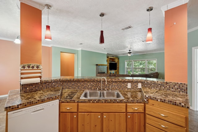 kitchen featuring sink, white dishwasher, pendant lighting, and decorative backsplash