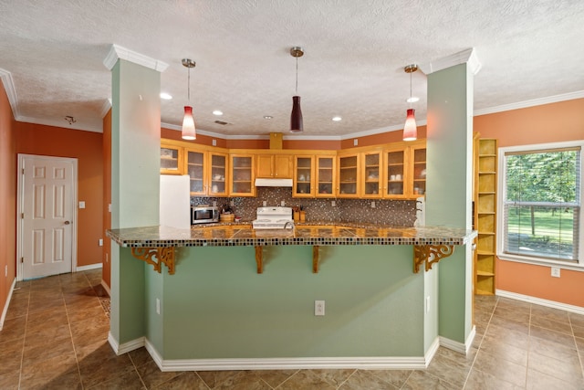 kitchen with white appliances, decorative light fixtures, tile patterned flooring, and decorative backsplash