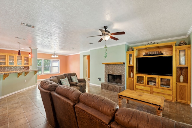 tiled living room with a textured ceiling, a fireplace, and ornamental molding