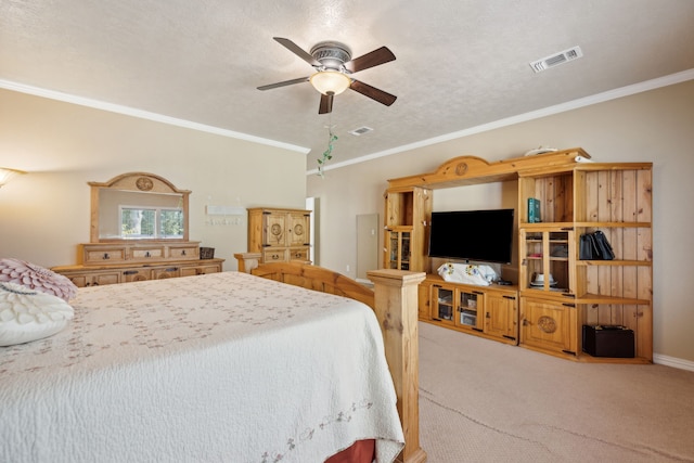 bedroom featuring light carpet, a textured ceiling, crown molding, and ceiling fan