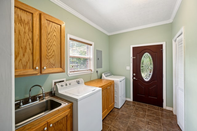 laundry room with cabinets, separate washer and dryer, ornamental molding, dark tile patterned floors, and sink