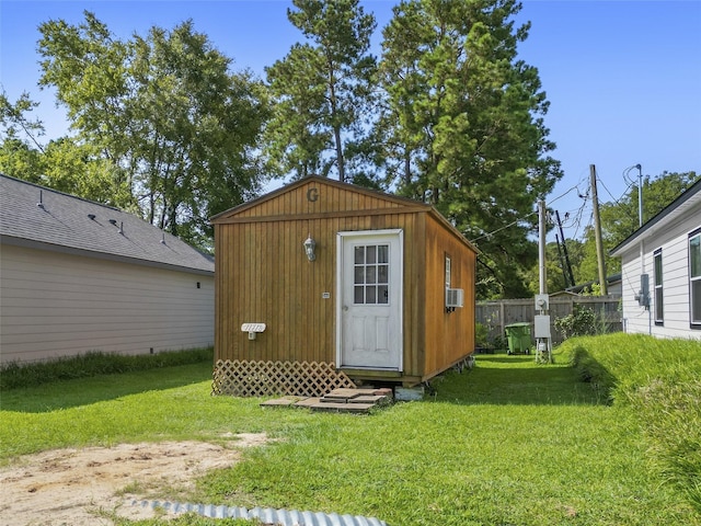 view of outbuilding featuring an outbuilding, cooling unit, and fence