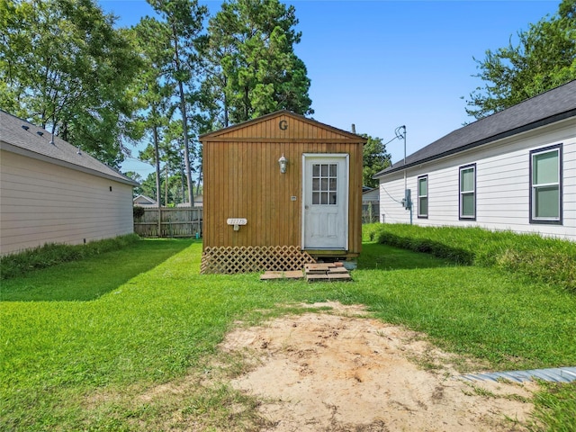 view of outbuilding with fence and an outbuilding