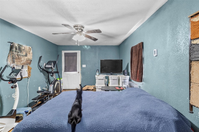 bedroom with a textured ceiling and ceiling fan