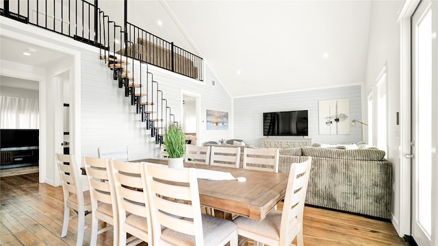 dining area featuring high vaulted ceiling and hardwood / wood-style flooring