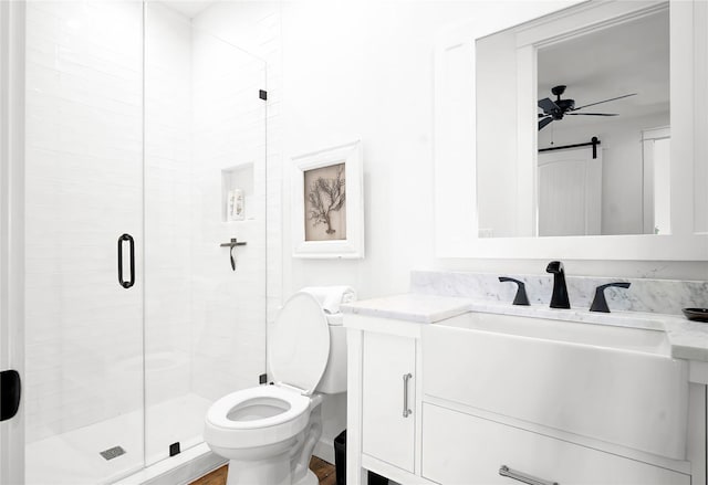 bathroom with a ceiling fan, a shower stall, vanity, and toilet