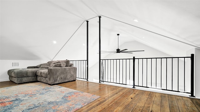 living area with light wood-style flooring, visible vents, vaulted ceiling, and a ceiling fan