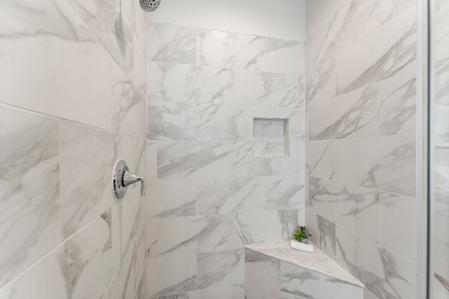 bathroom featuring tiled shower