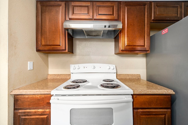 kitchen featuring refrigerator and white electric stove