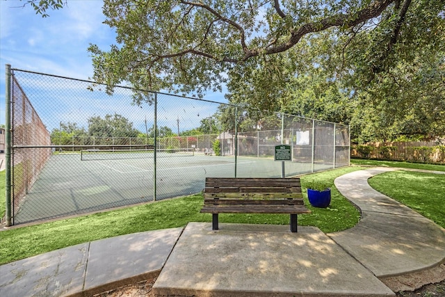 view of sport court featuring a lawn