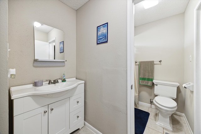 bathroom with a textured ceiling, vanity, toilet, and tile patterned flooring