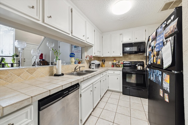 kitchen with black appliances, sink, backsplash, and white cabinets