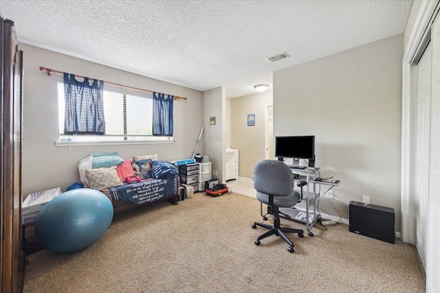 carpeted office space with a textured ceiling