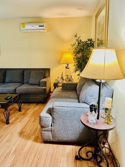 30470 Reids Prairie Rd, Waller, TX 77484 - living room with a wall unit AC and wood finished floors