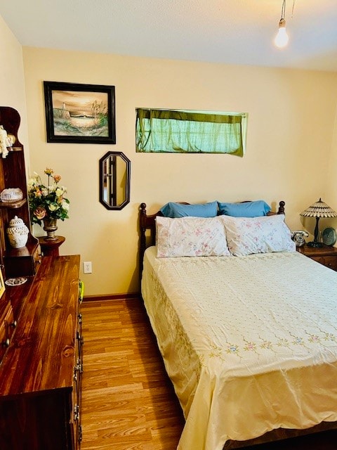 bedroom with wood-type flooring