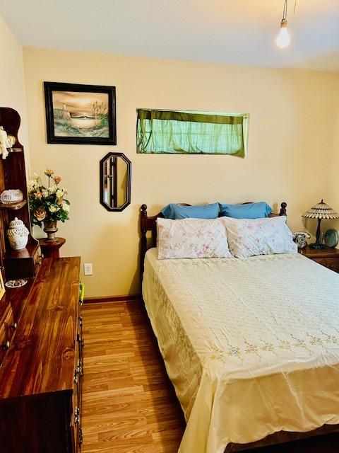 30470 Reids Prairie Rd, Waller, TX 77484 - bedroom featuring wood finished floors and baseboards
