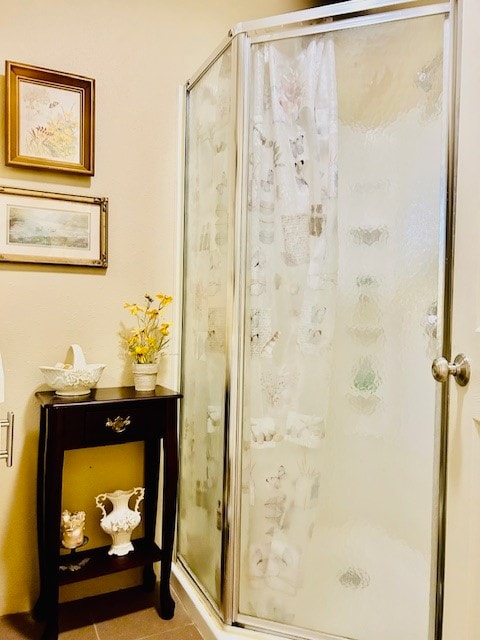 bathroom featuring tile patterned flooring and a shower with shower door