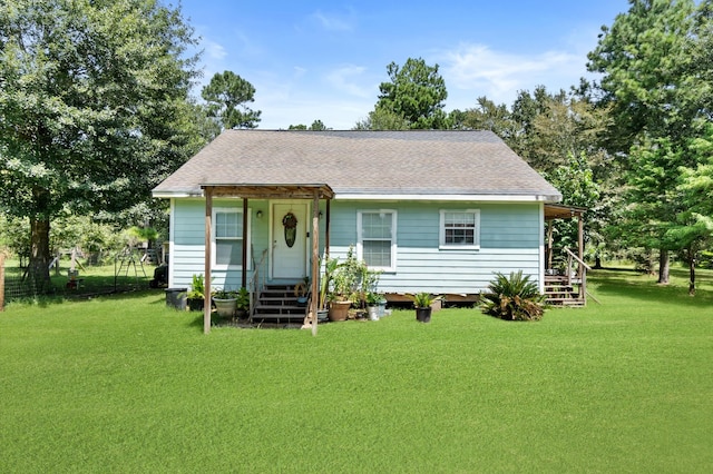 back of property featuring a yard