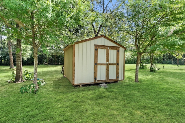 view of outdoor structure featuring a lawn