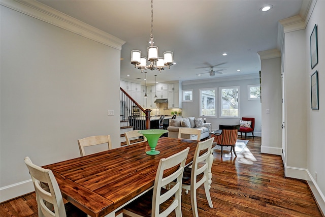 dining space with ceiling fan with notable chandelier, crown molding, and hardwood / wood-style flooring