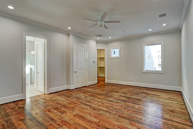 unfurnished bedroom featuring ceiling fan, hardwood / wood-style floors, and connected bathroom