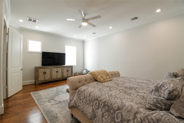 bedroom featuring ceiling fan, dark wood-type flooring, and ornamental molding