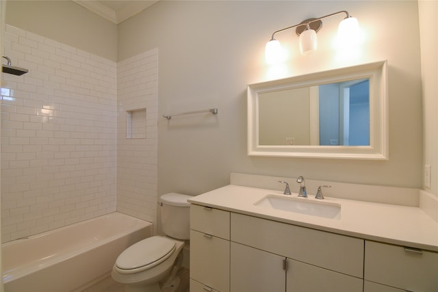 full bathroom featuring toilet, tiled shower / bath combo, vanity, and ornamental molding