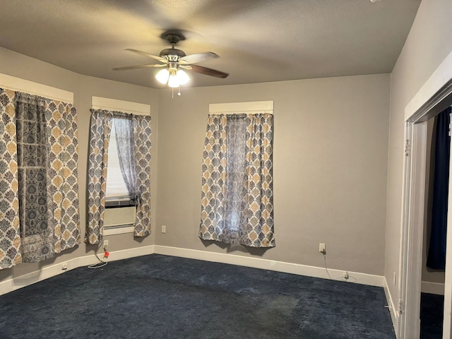 carpeted spare room featuring ceiling fan and a textured ceiling