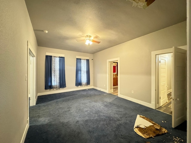 carpeted empty room featuring a textured ceiling and ceiling fan