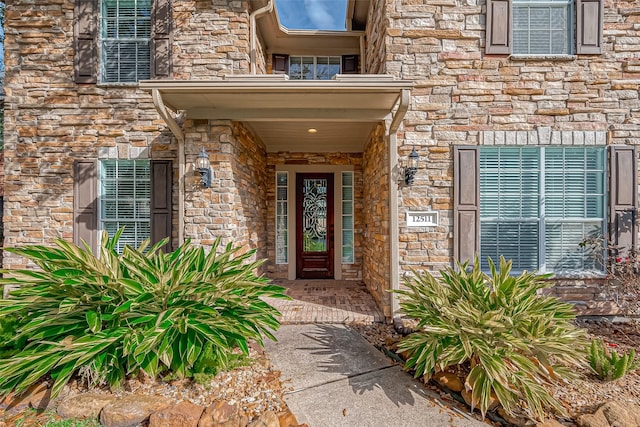 view of exterior entry featuring stone siding