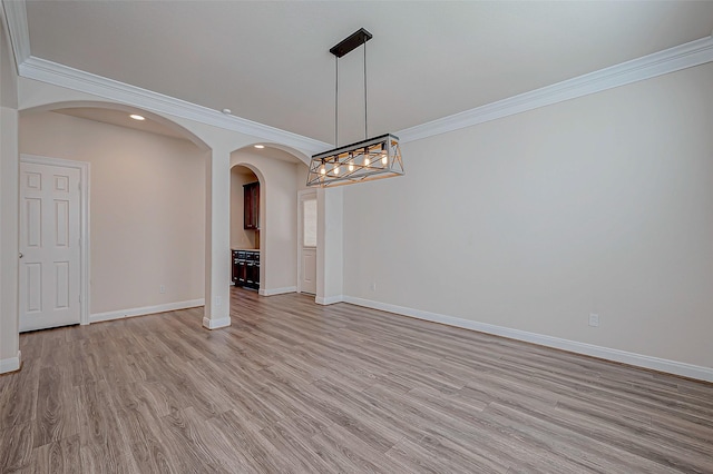 unfurnished dining area featuring crown molding and light hardwood / wood-style floors