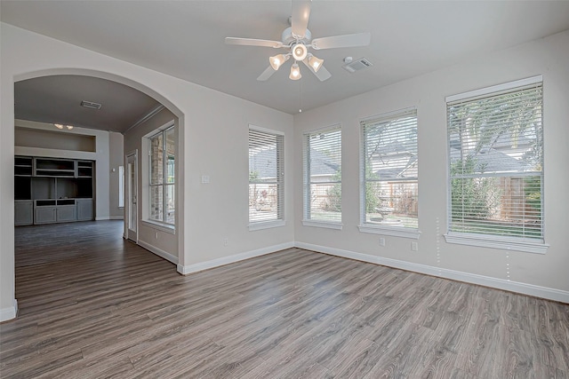 empty room with ceiling fan and hardwood / wood-style floors