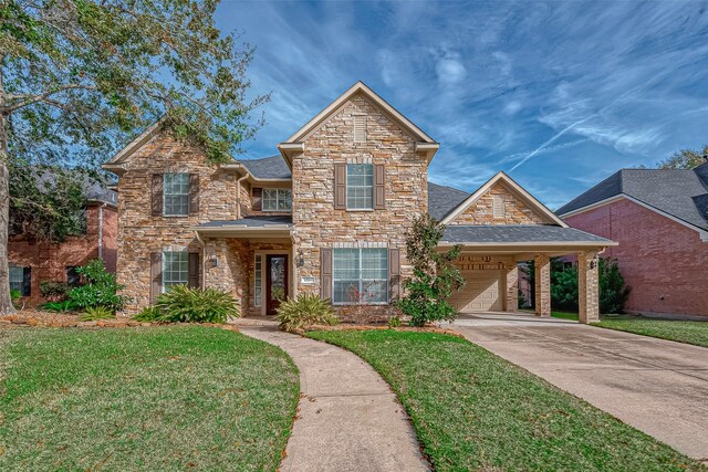 view of front property featuring a front yard, a garage, and a carport