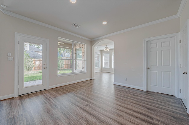 interior space featuring visible vents, wood finished floors, and ornamental molding