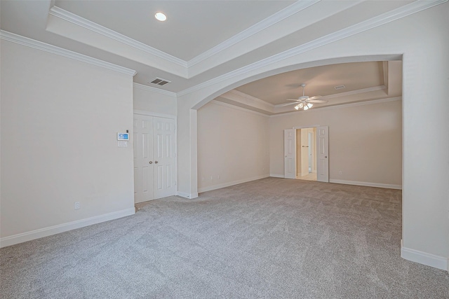 unfurnished room featuring ceiling fan, carpet flooring, crown molding, and a tray ceiling