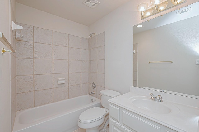 full bathroom with tiled shower / bath combo, vanity, and toilet