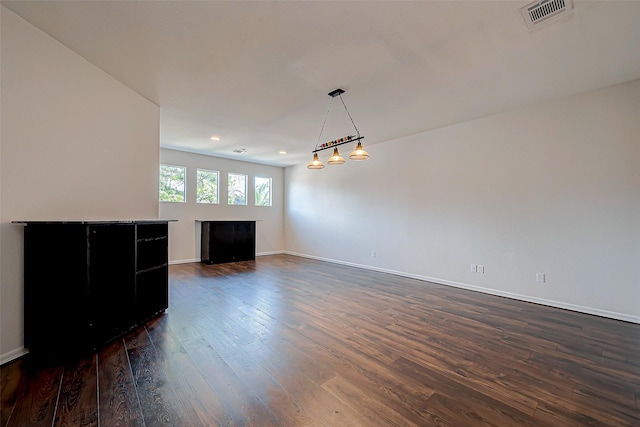 unfurnished living room featuring dark hardwood / wood-style floors