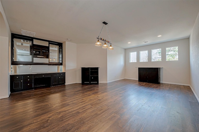 unfurnished living room featuring dark wood finished floors, visible vents, recessed lighting, and baseboards