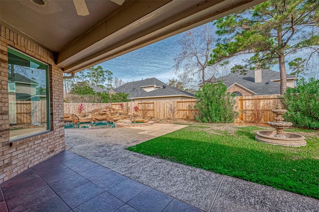 view of yard featuring a patio area and ceiling fan