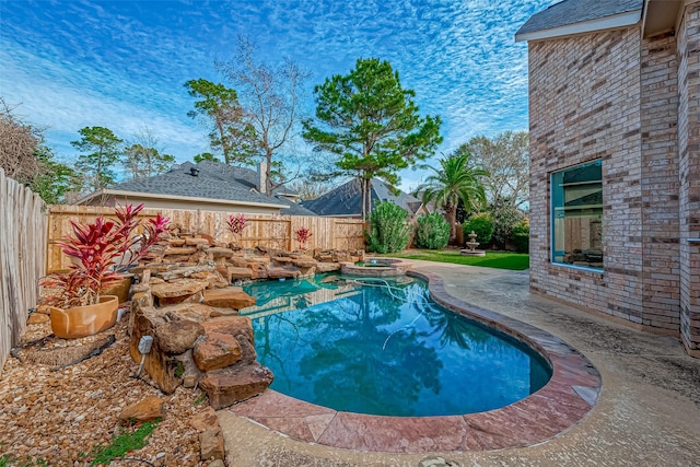 view of swimming pool featuring a patio and an in ground hot tub