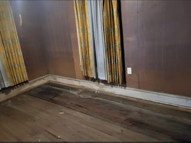 unfurnished room featuring wood-type flooring