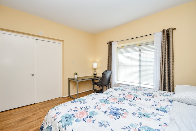 bedroom featuring light wood-type flooring and a closet