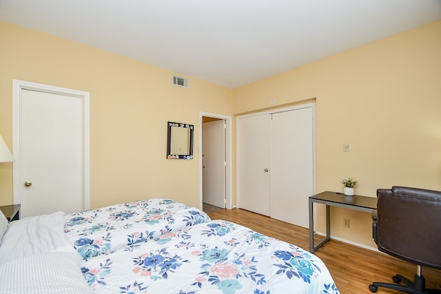 bedroom featuring light wood-type flooring and a closet